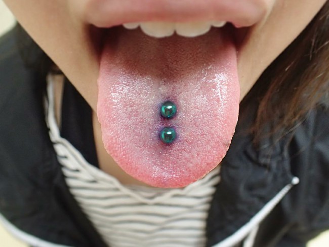 two tongue piercings