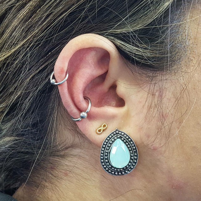 Helix piercing: pain, healing, jewelry - obsidian piercing